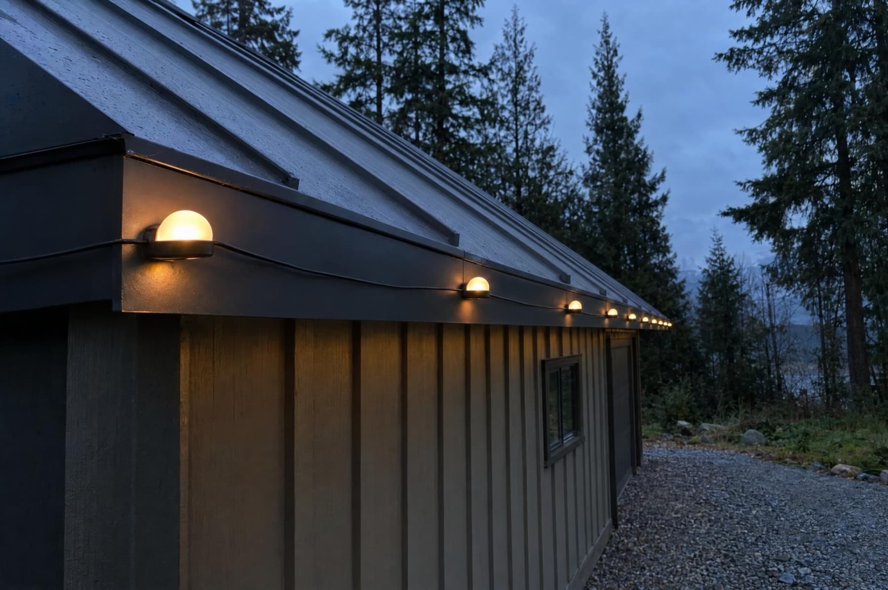Magnetic pebble lights on the steel drip edge of a metal-roofed shop