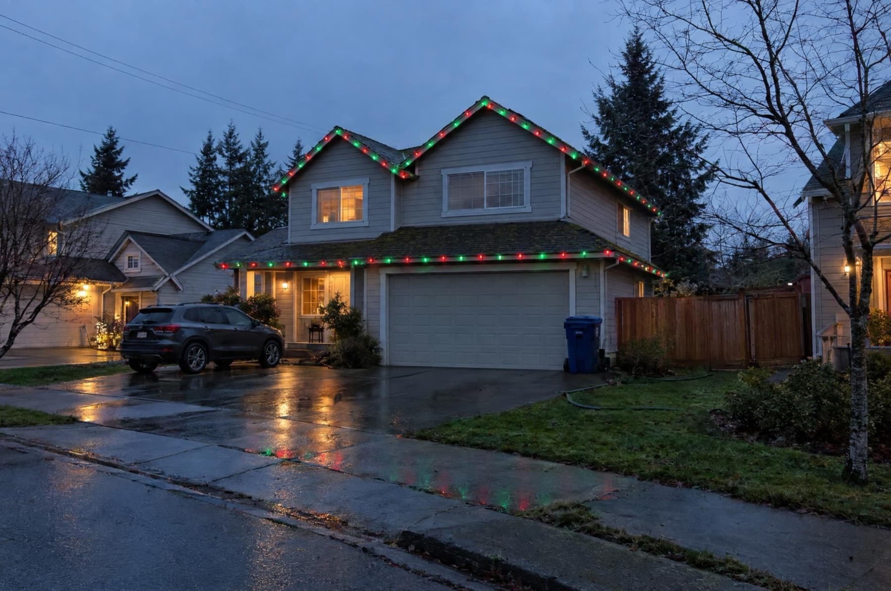 Subdivision two-story with red and green C9 strands on the roofline and garage