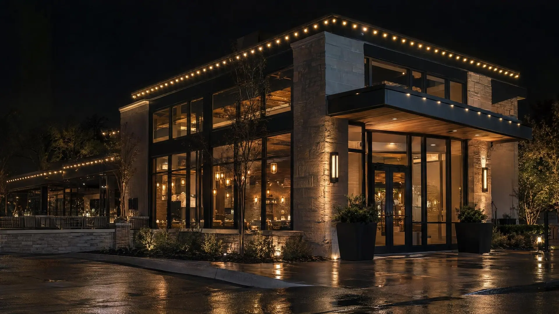 Illustration of a small storefront at night with warm-white permanent lights along the parapet and entrance