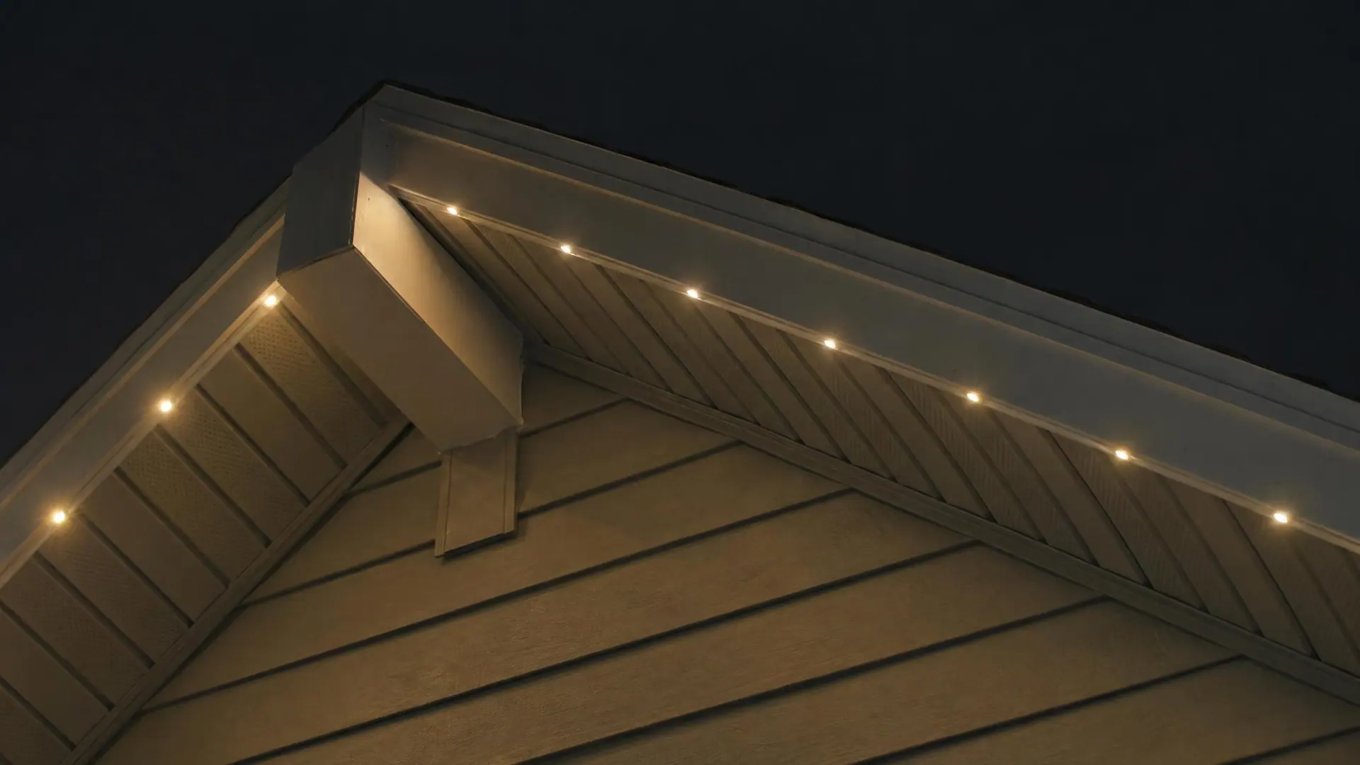 Illustration: night close-up of a gable peak outlined in evenly spaced warm-white LED points against a black sky