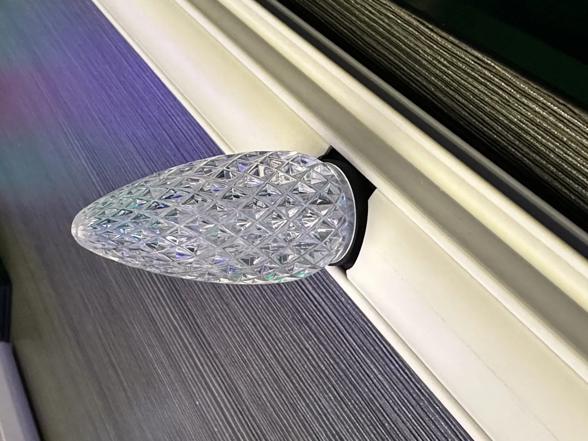 Minleon faceted C9 bulb seated in white track covers