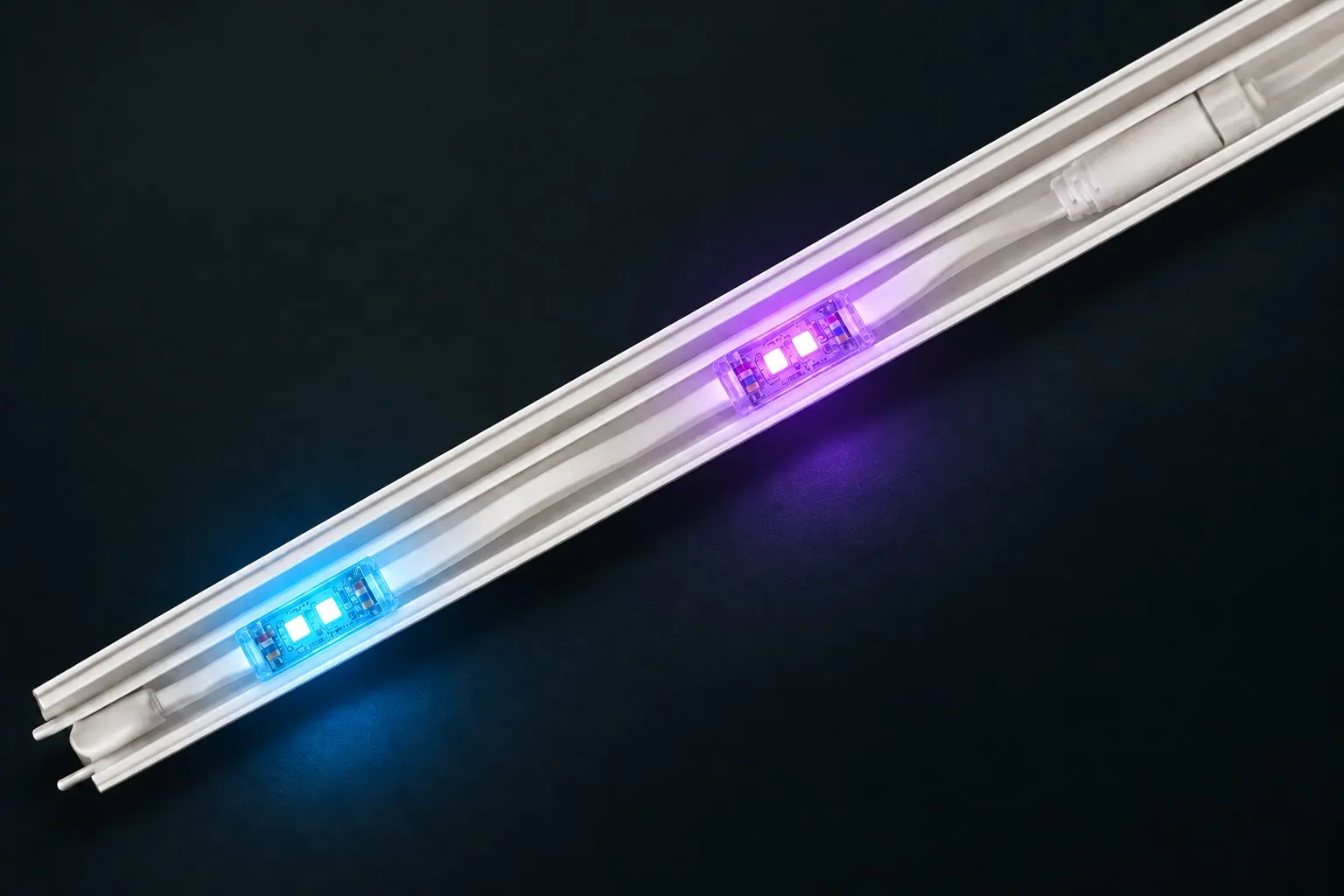 Pebble nodes emitting bright cyan and violet light in an open white channel